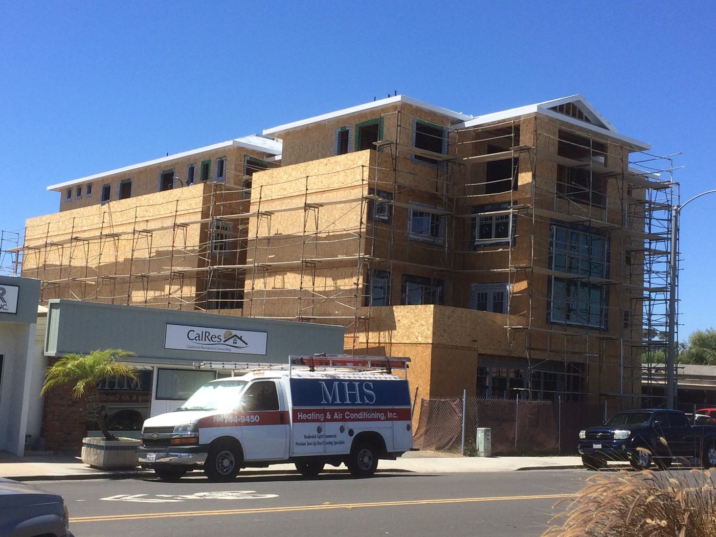 Window installation in progress on a multi-unit building