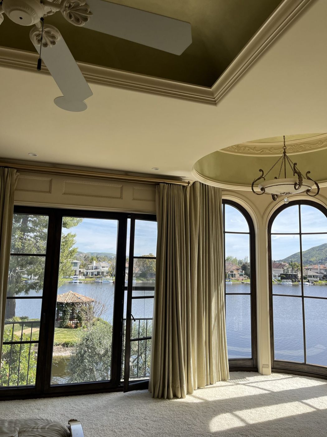 Finished arched French doors and window with a lake view