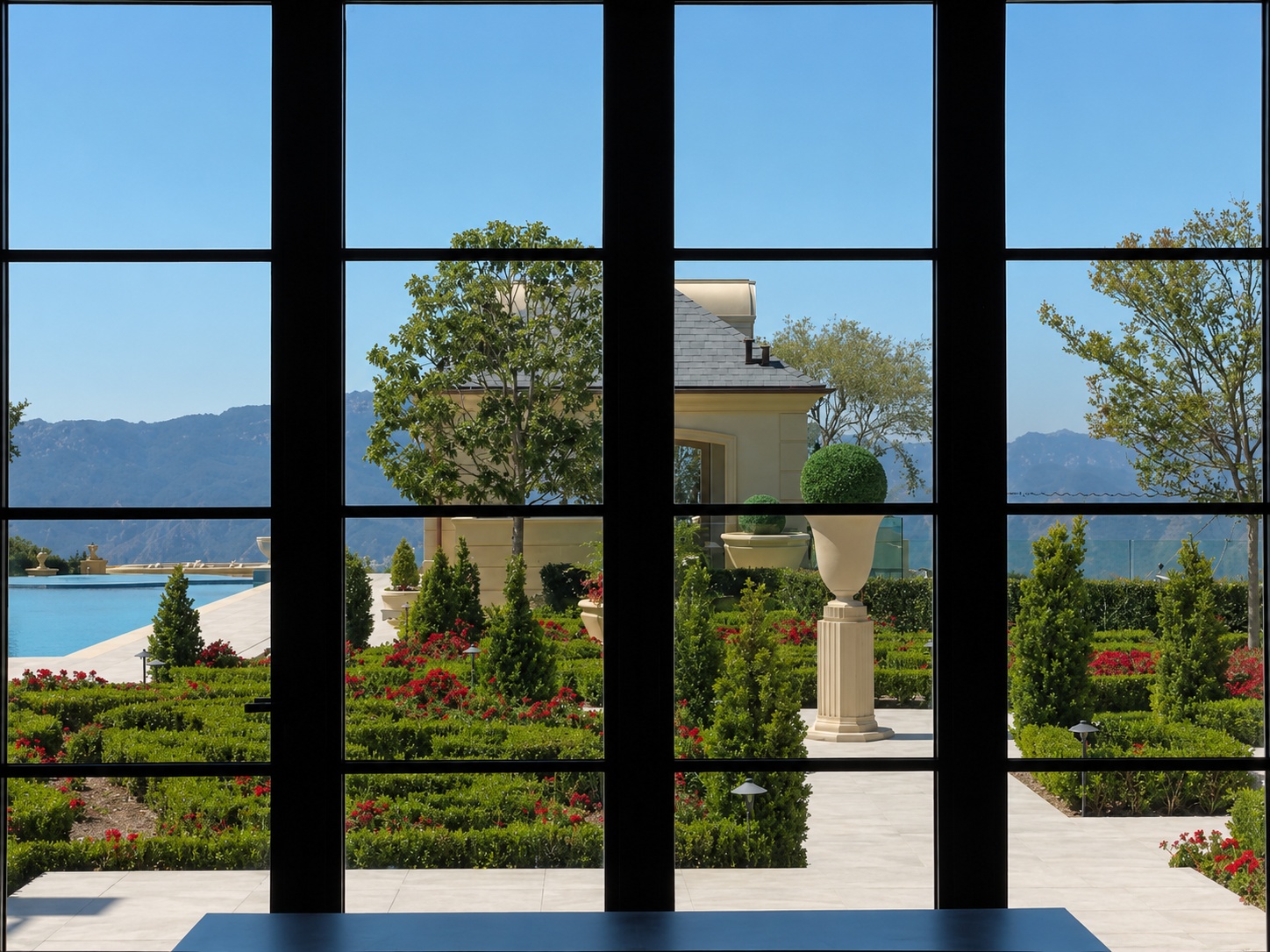 Large multi-pane windows overlooking a landscaped garden and pool